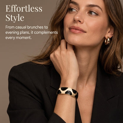 Model styling NAXAYA Modern Noir black and gold-tone kada bracelet with a black blazer, with the caption Effortless Style.