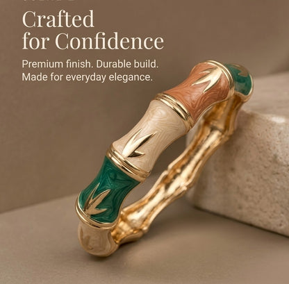 NAXAYA Bamboo Muse bamboo-design enamel bangle on beige stone with the caption Crafted for Confidence.