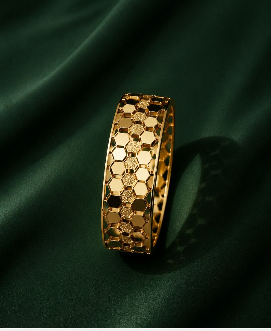 NAXAYA Hexovra gold bracelet with luxury honeycomb pattern on emerald green background