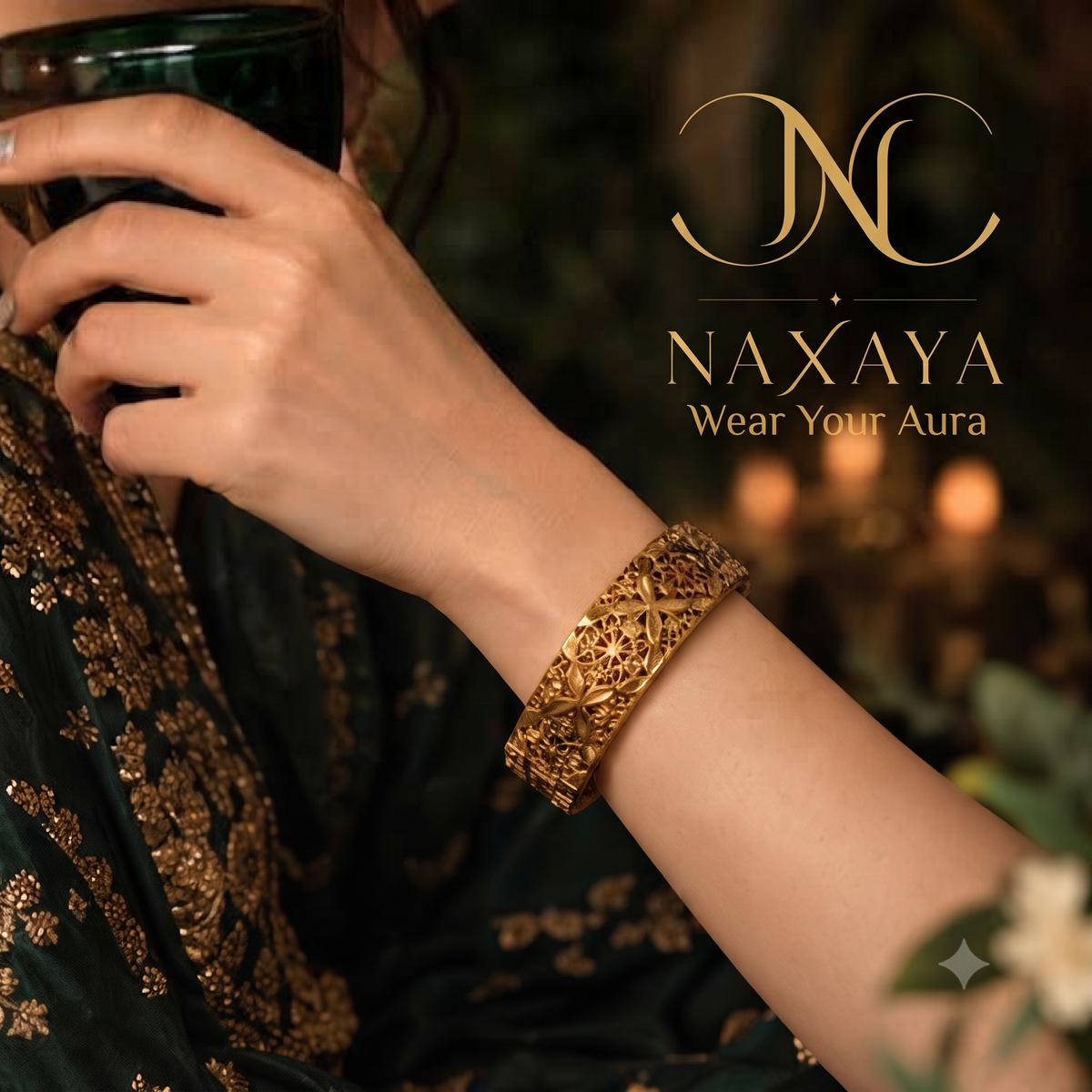  Close-up of Naxaya traditional gold filigree cuff bracelet worn on a wrist.