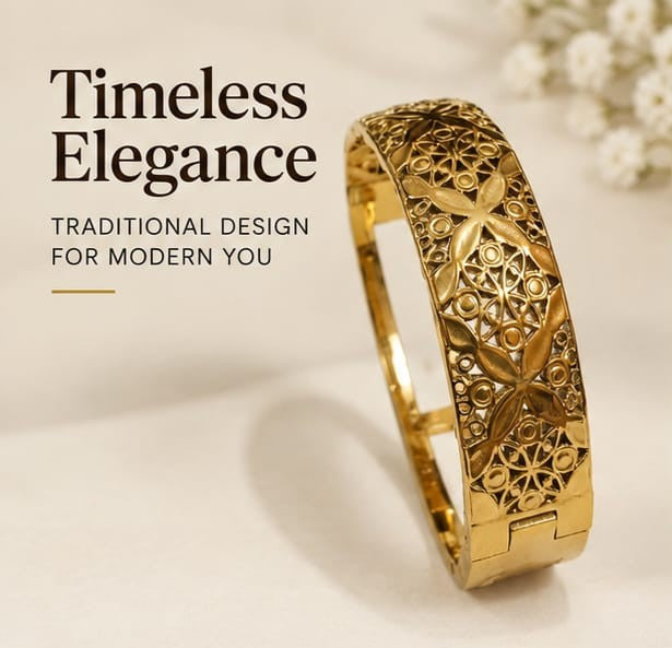 Broad gold plated filigree wedding kada bangle on white aesthetic surface.