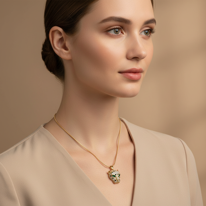 Woman in a beige outfit wearing a NAXAYA gold-tone necklace with a green-eyed panther pendant.